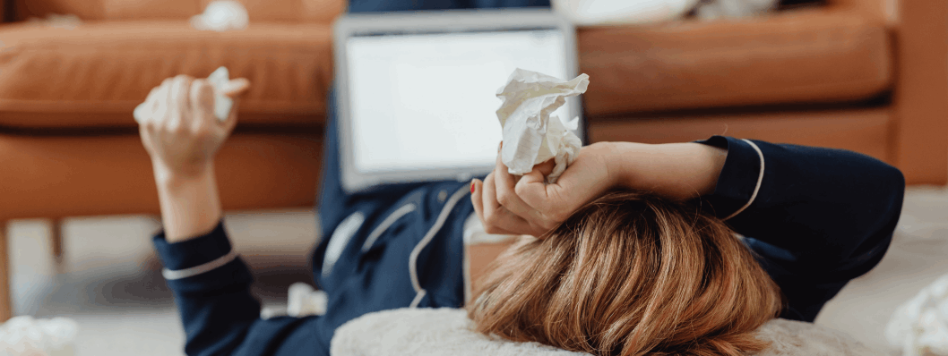 Woman at home sick holding tissues; allergies or histamine overload?