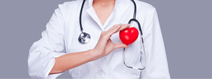 Medical professional holding a red heart symbolizing integrative heart disease prevention, cardiovascular care, and holistic medicine at West Holistic Medicine
