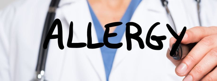 Doctor writing the word “Allergy” on a clear screen, representing allergy testing and treatment at West Holistic Medicine in Austin, Texas.