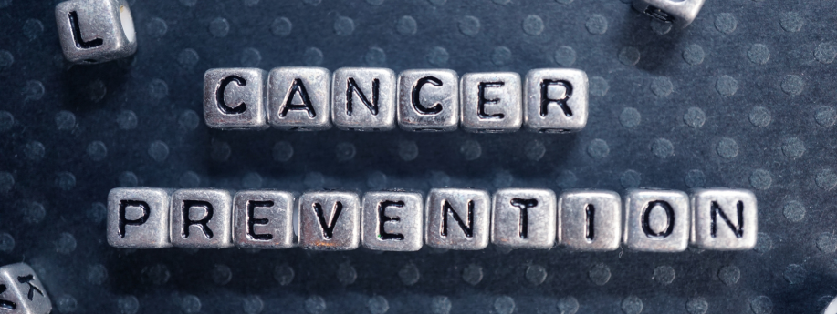 Close-up of metal letter tiles arranged to spell ‘cancer prevention’