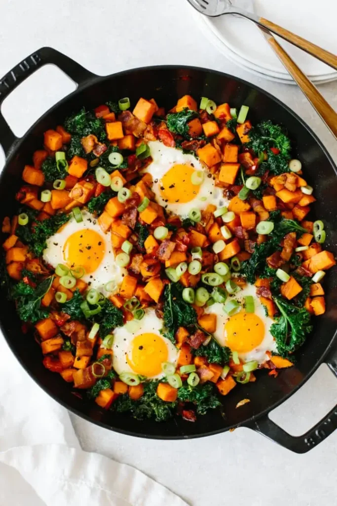 Sweet potato breakfast hash with eggs, kale, bell peppers and green onions for a colorful, nourishing fall breakfast.